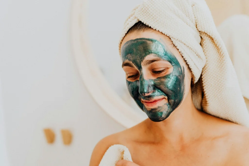 Woman applying neem powder face pack for glowing skin